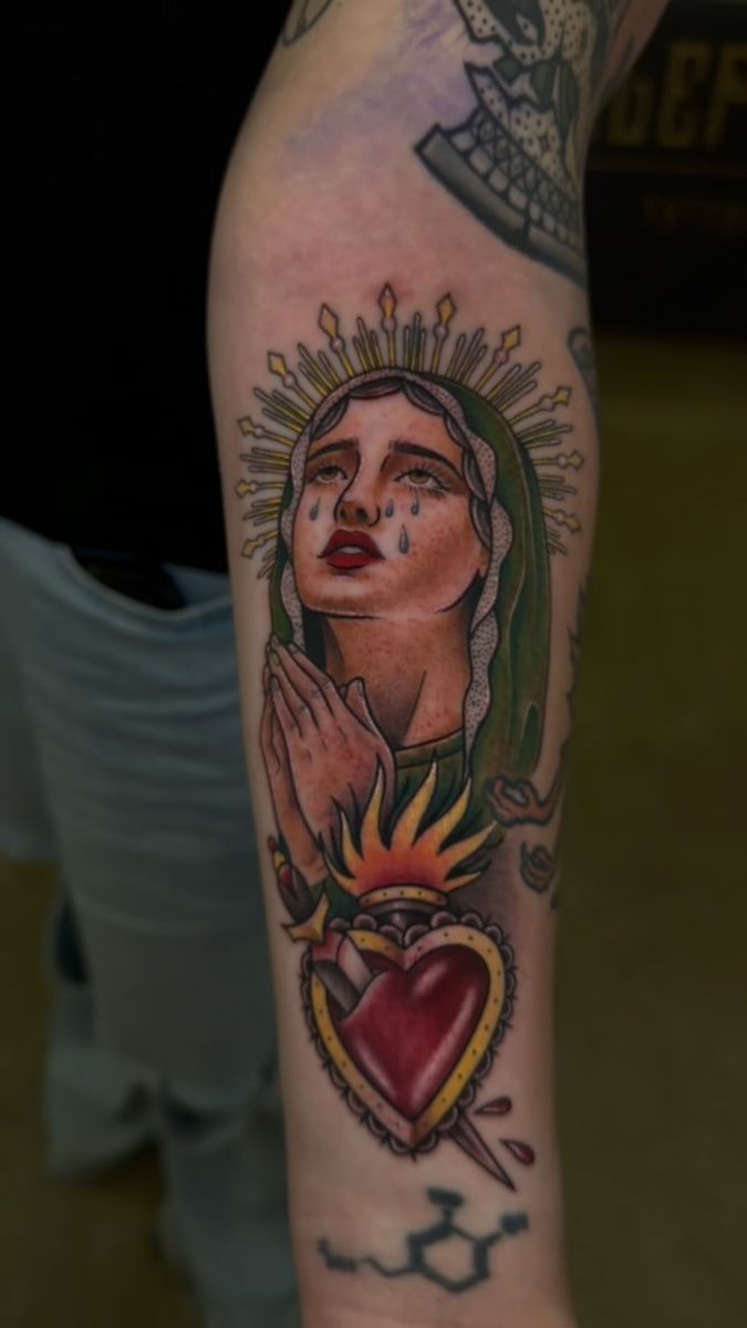 Traditional Virgin Mary with a sacred heart on an arm