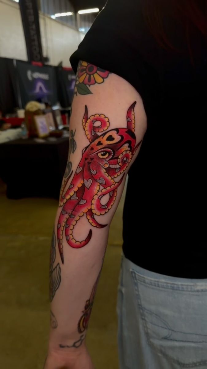 Traditional red octopus cover-up with heart spots on an elbow