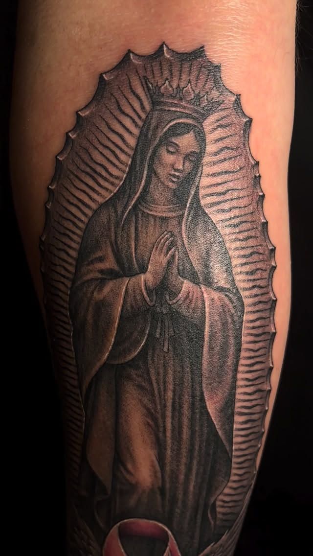 Black and grey Virgin of Guadalupe on a forearm