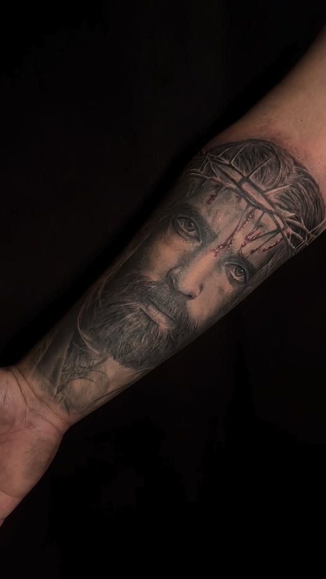 Black and grey realism Jesus on a forearm