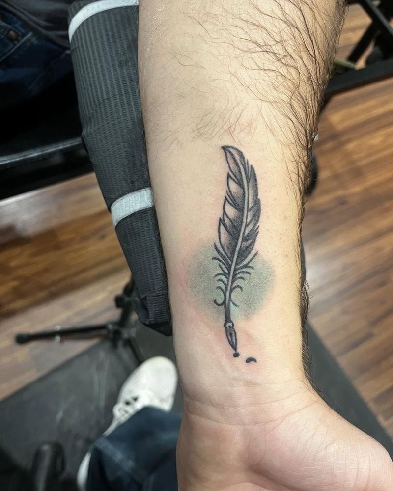 Feather quill on a wrist with a soft green wash