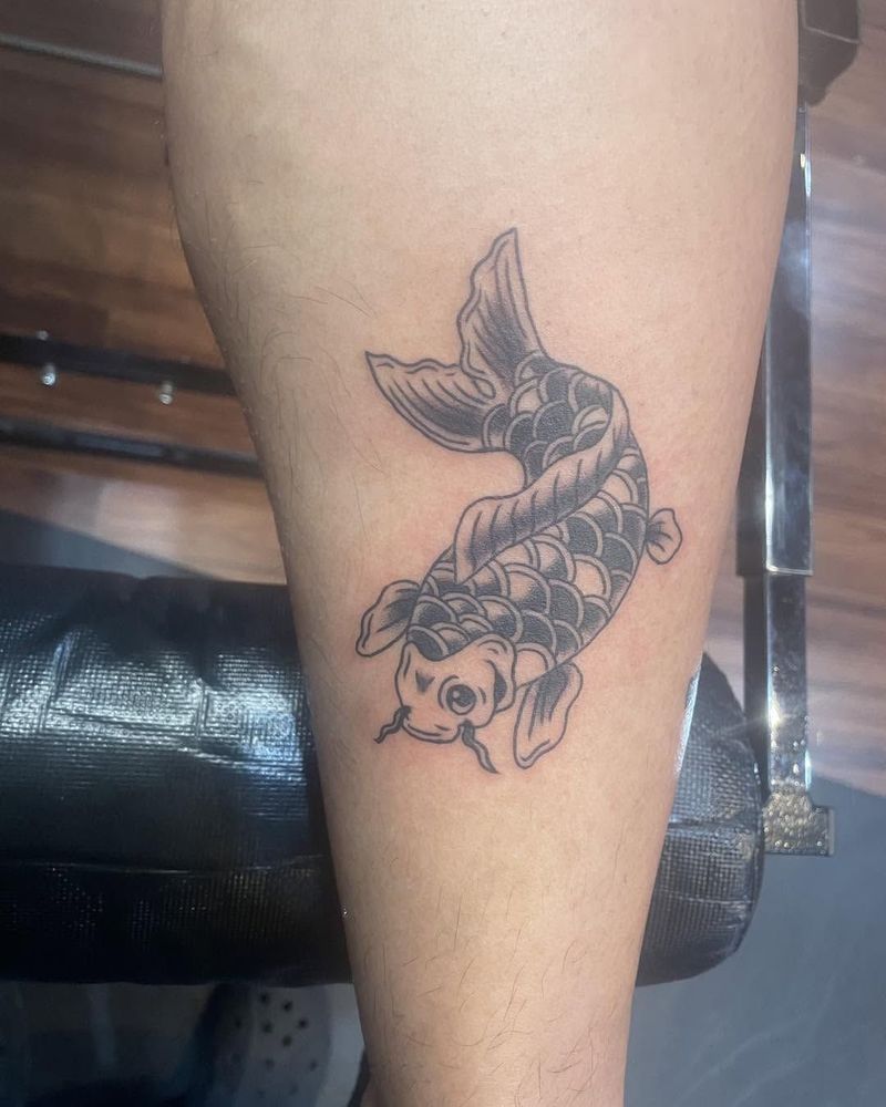 Black and grey koi fish on a forearm