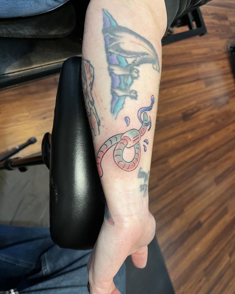 Snake and a colored creature on a wrist and forearm