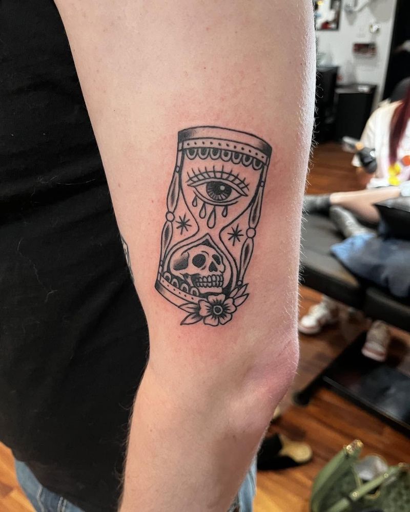 Hourglass with an eye and a skull on an arm