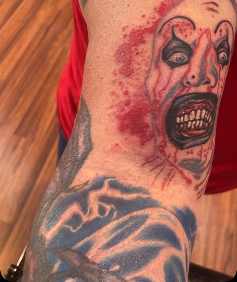 Color horror clown from Terrifier on an arm