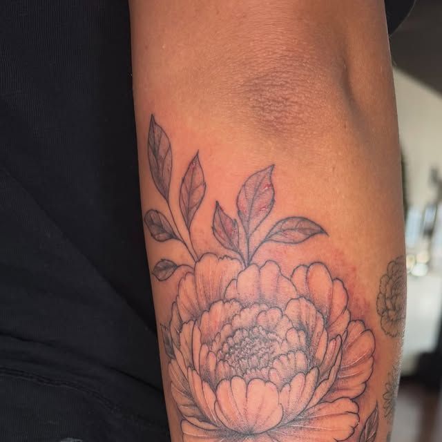 Fine line peony with leaves on an arm