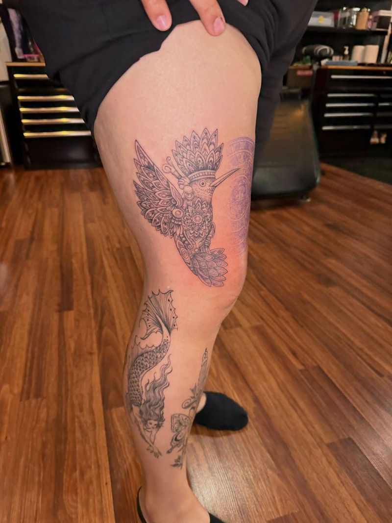 Fine line hummingbird and flowers on a leg